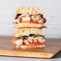 Procuitto And Chicken · Grilled sliced chicken with proscuitto, fresh mozzarella, sliced tomato, mixed greens, and b...