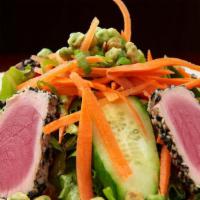 Sesame Tuna Salad · Medium rare tuna, baby greens, cucumbers, carrots, scallions, wasabi peas, ginger-soy vinaig...