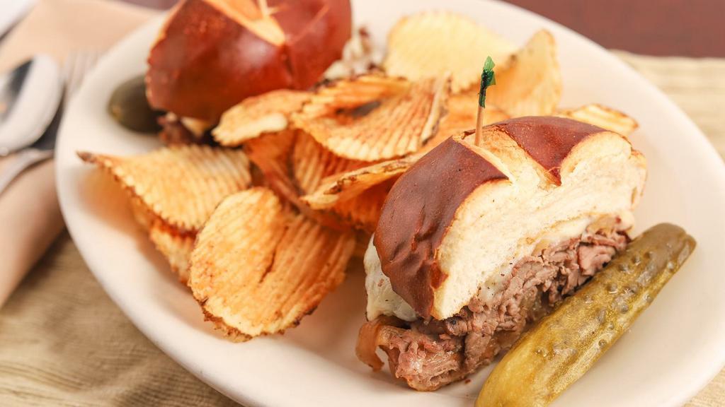 Roast Beef Pretzel · House-made roast beef, caramelized onions, Swiss cheese, dijon-horseradish sauce on a toasted pretzel roll - side house chips.