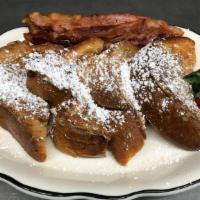 French Toast · Fancy thick sliced bread dipped in cinnamon, brown sugar and vanilla batter topped with powd...