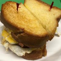 Texas Breakfast Sandwich · Three eggs and cheese with Bacon, Ham, or sausage on Texas toast