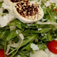 Wild Baby Arugula Salad · Warm Goat Cheese, Shaved Fennel, Grape Tomatoes, Parmesan & Grainy Mustard Dressing.