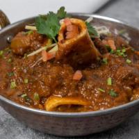 Goat Curry · Goat meat cooked with mild spices and herbs.