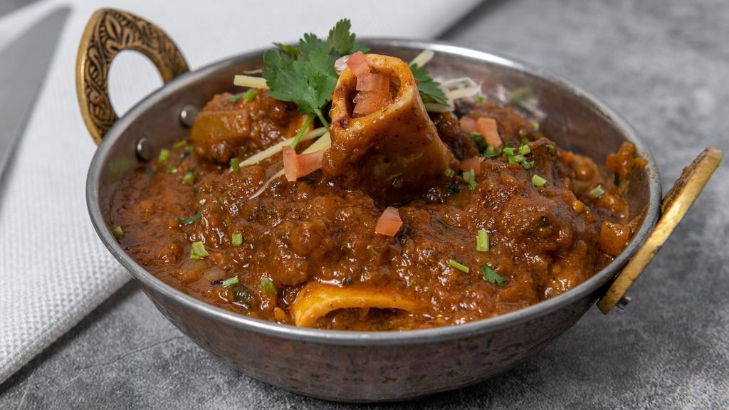 Goat Curry · Goat meat cooked with mild spices and herbs.