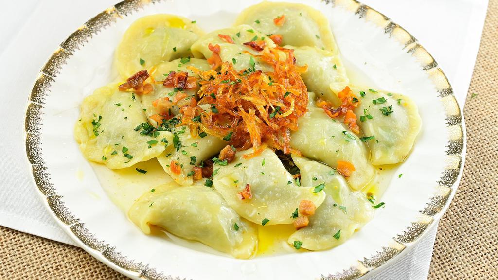 Pierogies “Shvabsky Style” · Handmade Pierogies with spinach and veal, served with crackling