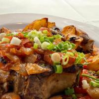 Kostiza (Moldovian Dish) · Cooked to perfection pork chop (bone in), served with braised vegetables and side dish of ho...