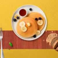 Bana Nut Pancakes · Fluffy pancakes cooked with care and love served with buttermilk, banana and walnut.