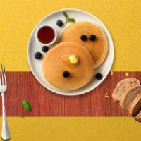Berry Nut Pancakes · Fluffy pancakes cooked with care and love served with buttermilk, blueberry and almond.