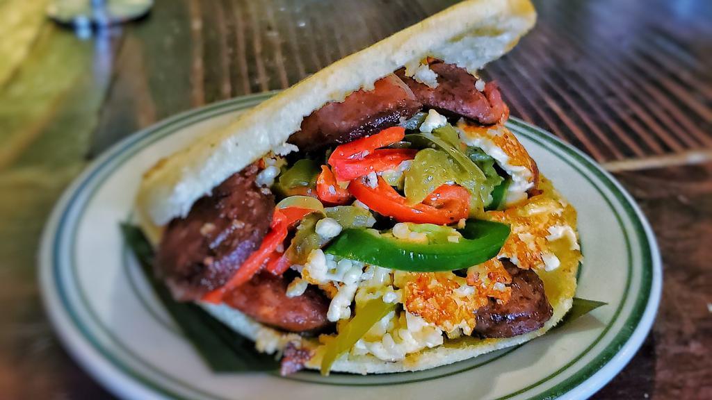 Los Muchachos (Gf) · Grilled chorizo, spicy white cheese with jalapeños and sautéed peppers.