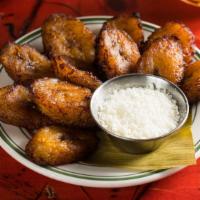 Tajadas · Fried sweet plantains with white salty cheese.