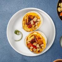 Sausage Page Breakfast Burrito · Sausage, eggs, tater tots, cheddar cheese, tomatoes and caramelized onions wrapped in a flou...