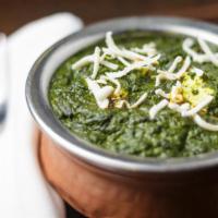 Palak Paneer · Fresh creamed spinach cooked with cubed homemade cottage cheese in delicate Indian spices.