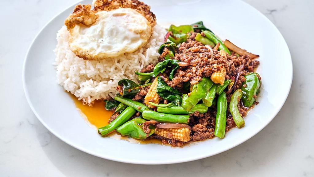 Grounded Beef Spicy Basil · Hot and spicy,  Ground beef, red onion, green bean, long hot green chili, garlic, fresh chili, baby corn with basil sauce, and a fried egg over rice.