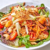Crispy Duck Salad · Roasted duck marinated mixed greens, pineapple, tomato, cashew nut, red onion, and scallion ...