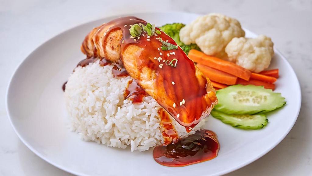 Salmon Over Rice · Grilled salmon and mixed vegetable, Sesame seed with teriyaki sauce.