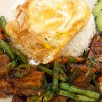 Dry Curry Crispy Pork Belly · Mild spicy. Pork belly, green bean, carrot, garlic, lime leave, Thai curry paste, fried egg.