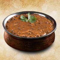 Creamy Black Lentils  · Black lentils slow cooked till tender and tempered with Indian spices and finished with fres...
