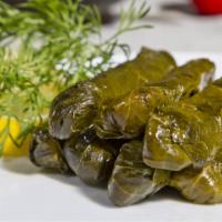 Grape Leaves · Hand rolled grape leaves stuffed with tomatoes, onions, lemon juice, and rice.