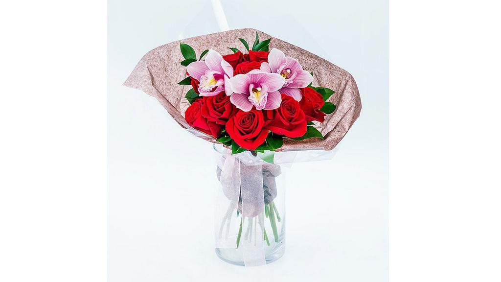Orchid & Rose · The Orchid & Rose arrangement is presented without a vase as a compact dome of red roses, pink cymbidium orchids, and ruscus. The bouquet's stems are left exposed and the bouquet is wrapped with a satin ribbon.
