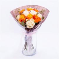 Creamsicle · The Creamsicle arrangement is presented without a vase as a compact dome of orange and cream...