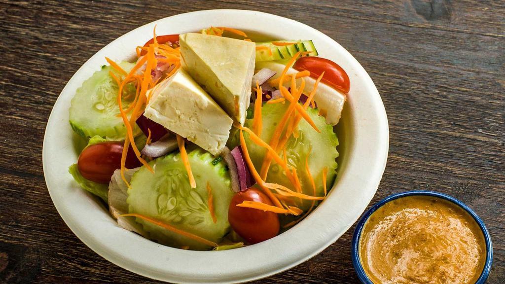 House Salad · Simply yet filling! Lettuce, onion, tomato, cucumber, carrots and steamed tofu with peanut dressing.