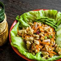 Chicken Larb · Steamed ground chicken breast tossed in a fish sauce lime vinaigrette, roasted rice, red oni...