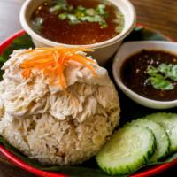 Khao Mun Gai · An exclusive item, only available on caviar! Steamed chicken over garlic rice served with fe...