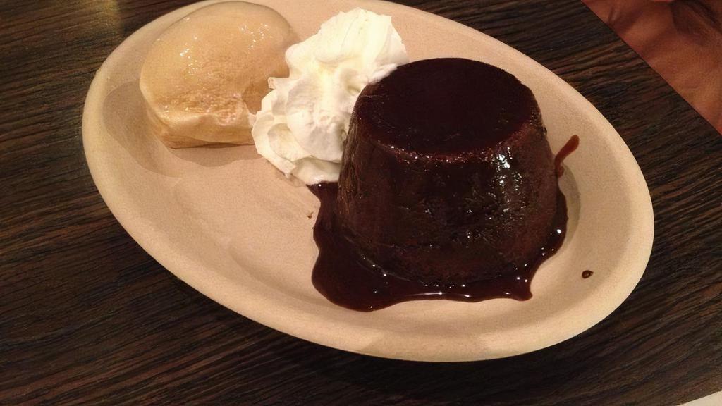 Molten Chocolate Cake With Caramel Sea Salt Ice Cream · Homemade Molten Chocolate Cake served with half scoop of all natural small batch homemade caramel sea salt ice cream and whipped cream.