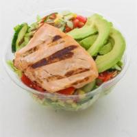Cali Salmon · Romaine, Grilled Salmon, Tomato, Corn, Cucumber, and Chickpea Crisps with an Avocado on top!...