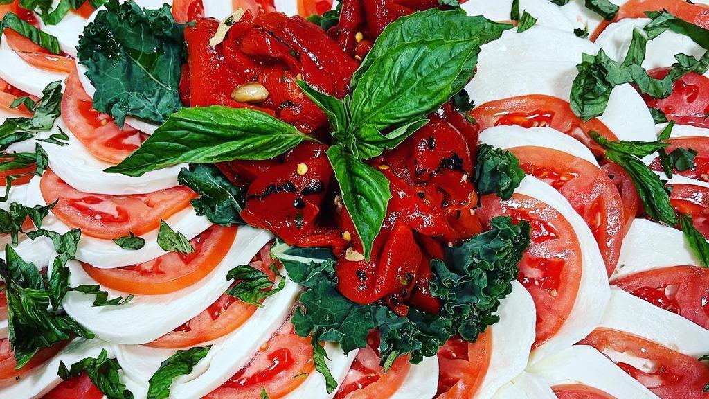 Mozzarella & Tomato · Four thick slices of our homemade fresh mozzarella and red ripe tomatoes on a bed of lettuce and fresh basil. Balsamic vinaigrette on the side.