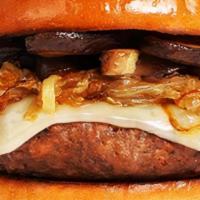The Texas Cowboy Burger · Beef patty with crisp bacon, fried onion rings, BBQ sauce, and melted cheddar cheese on a fl...