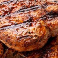 Grilled Pork Chops · center-cut pork chops served with applesauce, mashed potatoes, and vegetable.