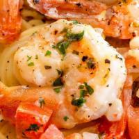 Shrimp Scampi · sautéed with whole cloves of garlic, white wine, fresh basil, and tomatoes, served over ange...