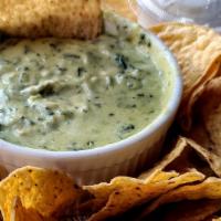 Artichoke & Spinach Dip · Fresh spinach and artichoke hearts blended with roasted garlic, swiss and Parmesan cheese. S...