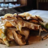 Chicken Madeira · Sautéed chicken breast topped with fresh asparagus and melted mozzarella cheese with a shiit...