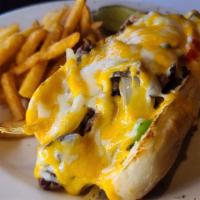 Philly Cheese Steak · Tender top sirloin, sautéed peppers, onions, melted Monterey jack and cheddar cheese on a he...