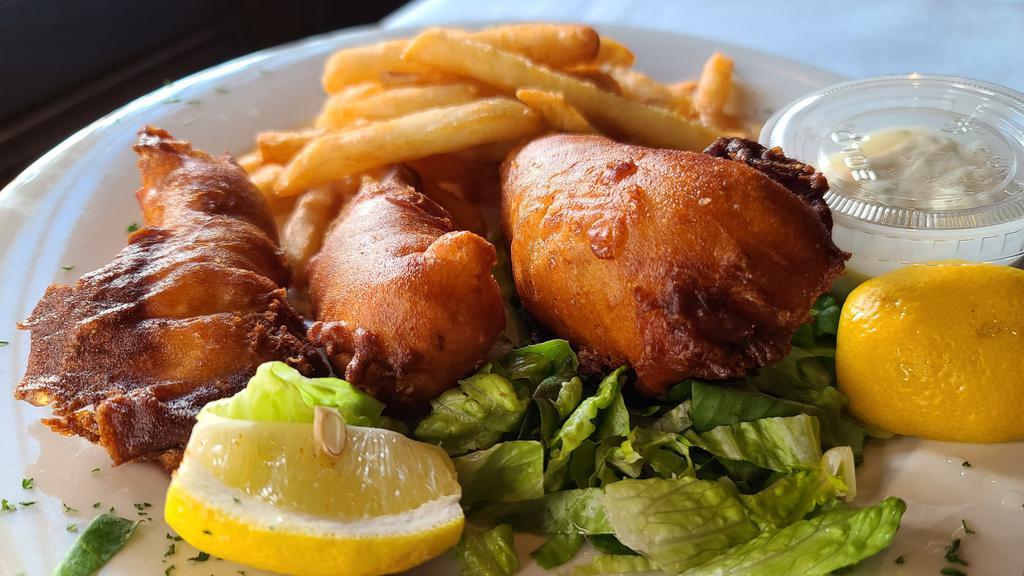 Fish & Chips · Filet of North Atlantic cod, beer battered and deep-fried. Served with french fries, cole slaw and a pickle.