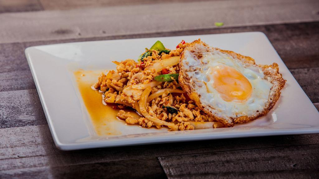 Traditional Thai Basil With Sunny  Side Egg · Mince chicken or Pork , Thai Basil, Thai chilies, bell Peppers, onion, garlic