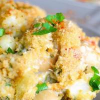 Crabcake Mac · Yummy crabcake ontop our homemade four cheese mac, baked with sweet tenderness