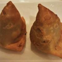 Vegetable Samosa · Crisp turnover filled with mildly spiced-potatoes and peas.