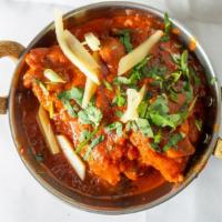 Goat Curry · Tender pieces of goat and with bone and cooked in authentic Indian curry.