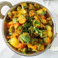 Bhindi Masala · Okra stuffed with exotic spices and cooked with onions and tomatoes. Vegetarian.