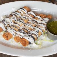 Chicken Tacos Dorados · Served with sour cream, black beans, fresh cheese and side of homemade salsa Verde.