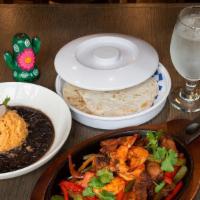 Mixed Fajita · Served with rice beans, sautéed peppers, onions and flour tortillas.