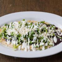 Huarache · Served with black beans, lettuce, sour cream, fresh cheese and side of homemade salsa Verde.