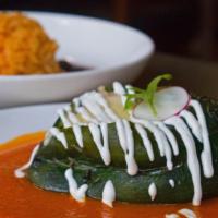 Shrimp Chile Relleno · Spicy. Roasted poblano pepper stuffed with shrimp, corn and jack cheese. Served with rice an...