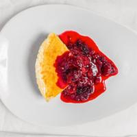 Mexican Cheesecake · Served with triple berry sauce.