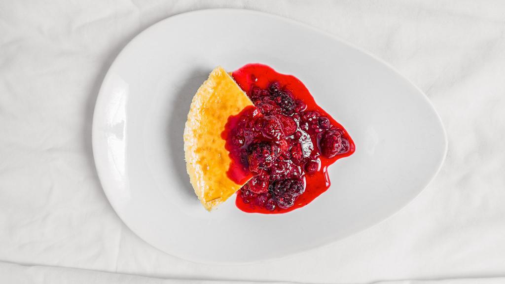 Mexican Cheesecake · Served with triple berry sauce.