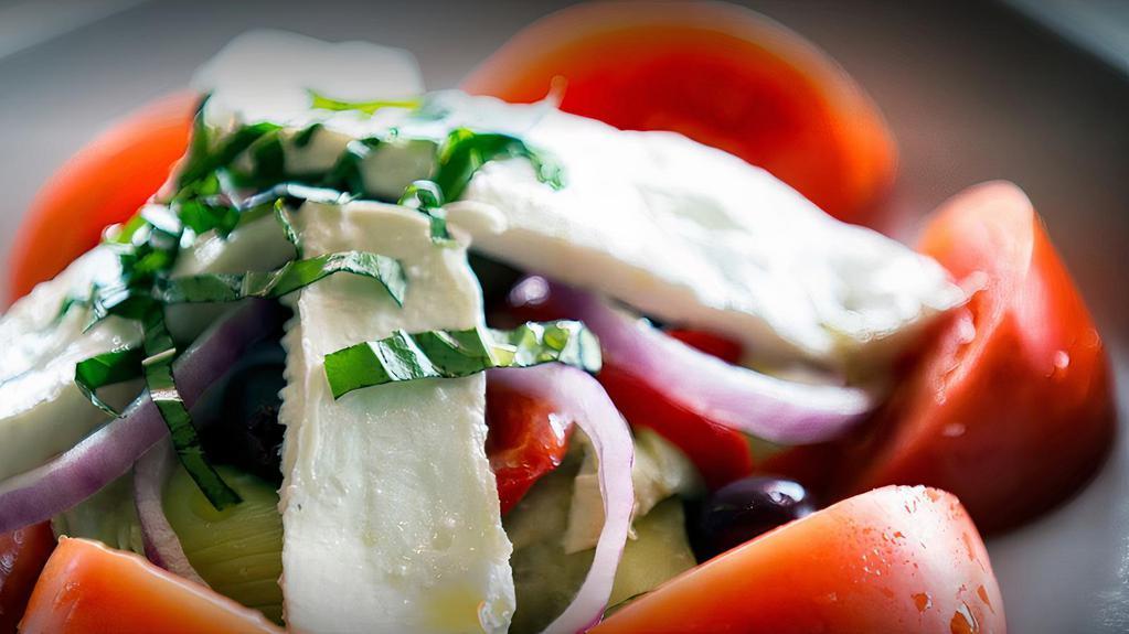 Caprese Salad · Fresh mozzarella, tomatoes, roasted red peppers, kalamata olives, fresh basil, artichoke hearts, red onions with creamy balsamic.