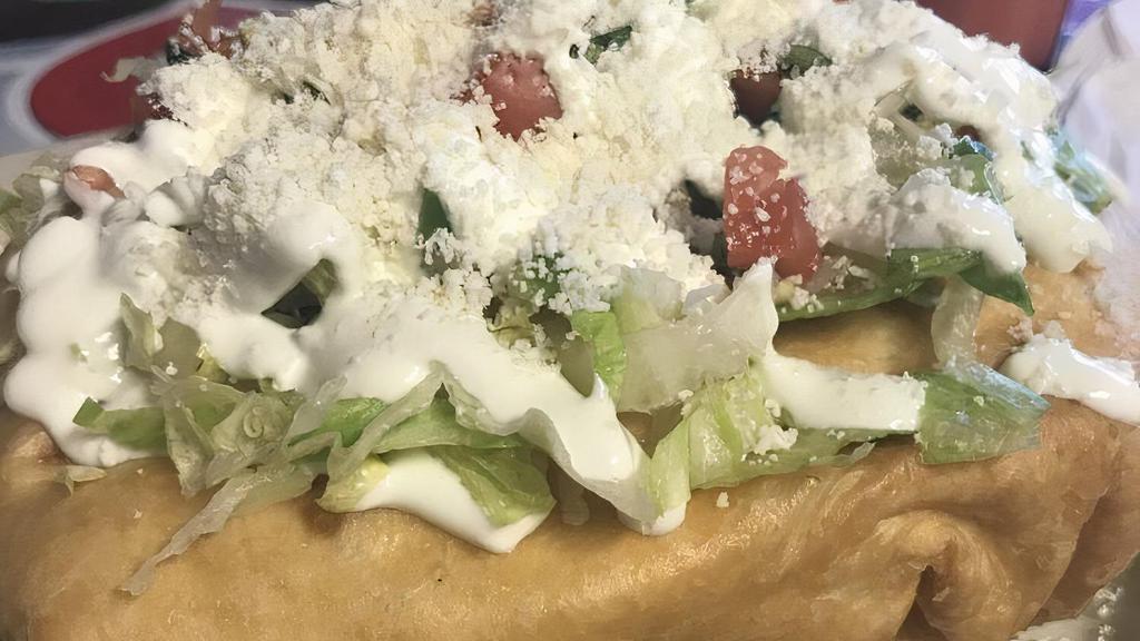 Chimichanga · Large Flour Tortilla stuffed with rice and beans, your choice of meat, Monterrey jack and chedder cheese, deep-fried to a crispy golden brown. Topped with lettuce, sour cream and pico de gallo
